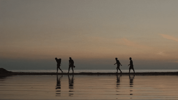 Silhouettes walking on the beach from "An Autumn Summer."