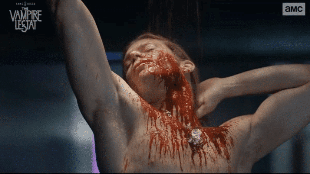 The Vampire Lestat bathes in blood, naked from the waist up, eyes shut.