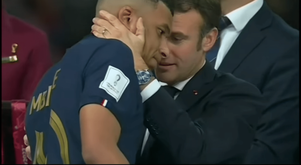 French President Emmanuel Macron consoles Kylian Mbappé following France's defeat to Argentina in the 2022 FIFA World Cup final.