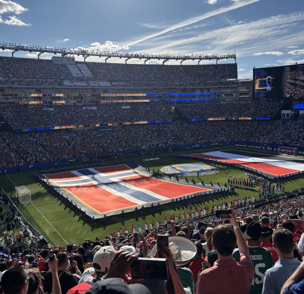 Massive flags for Norway and Iraq are presented during the opening ceremony. Each flag takes up nearly half the field.