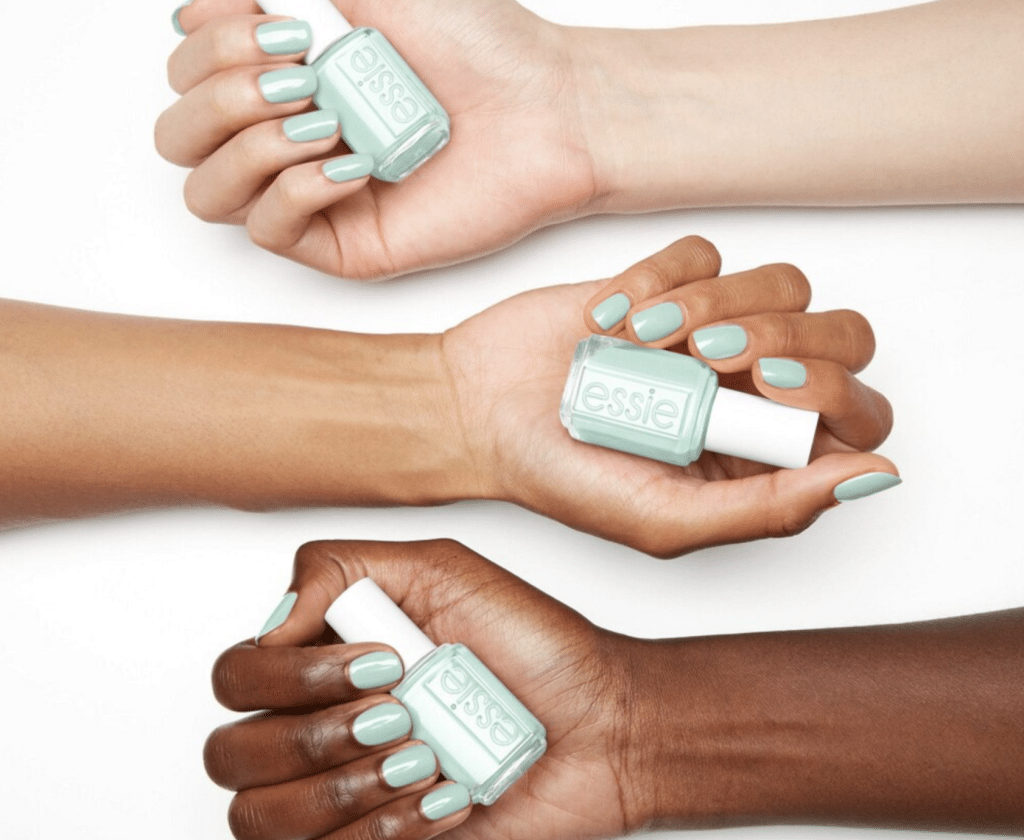 "seas the day" shade is modeled on the nails of three different skin tones, done by having one hand from each skin tone laid against a white background with all 5 respective fingers painted.