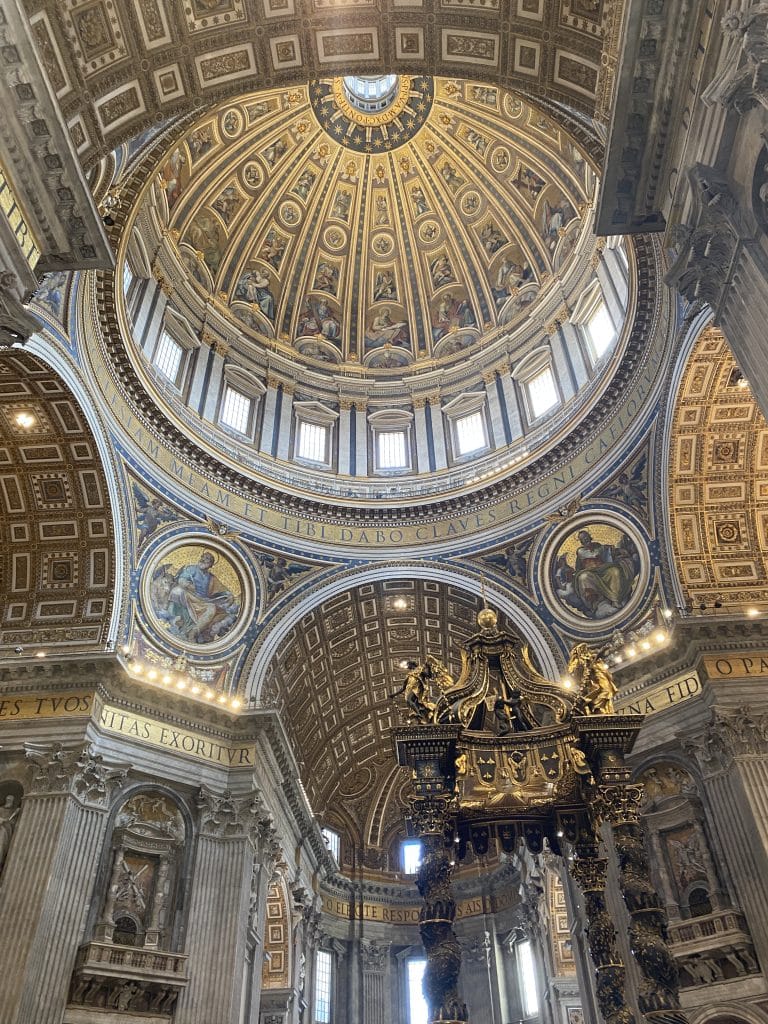 The beautiful golden arched ceiling of St. Peter's Basilica, a cathedral that it took a long journey to get to.