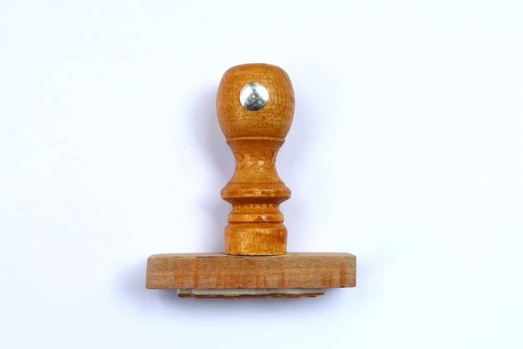 It's a stamp. That's about it. A wooden stamp with a metal circle on the handle.