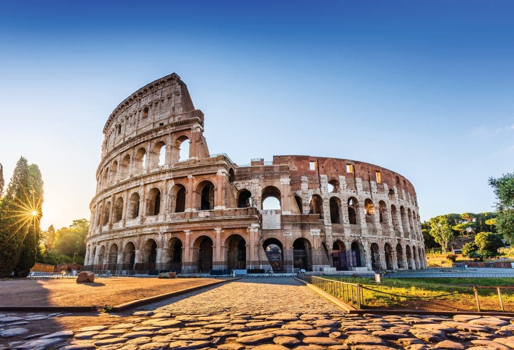 A picture of the Colosseum interposed against a beautiful blue sky.