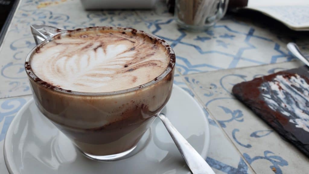 Cute picture of a coffee cup with the milk in a leaf shape.