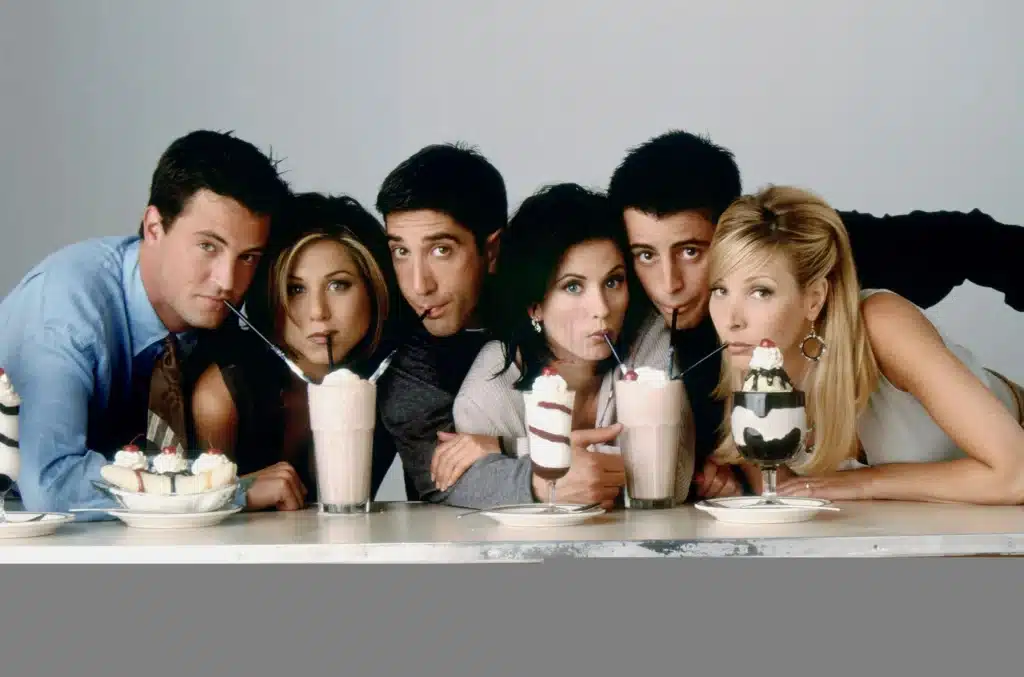 TV series "Friends" characters (Chandler, Rachel, Ross, Monica, Joey, and Phoebe) are drinking milkshakes.