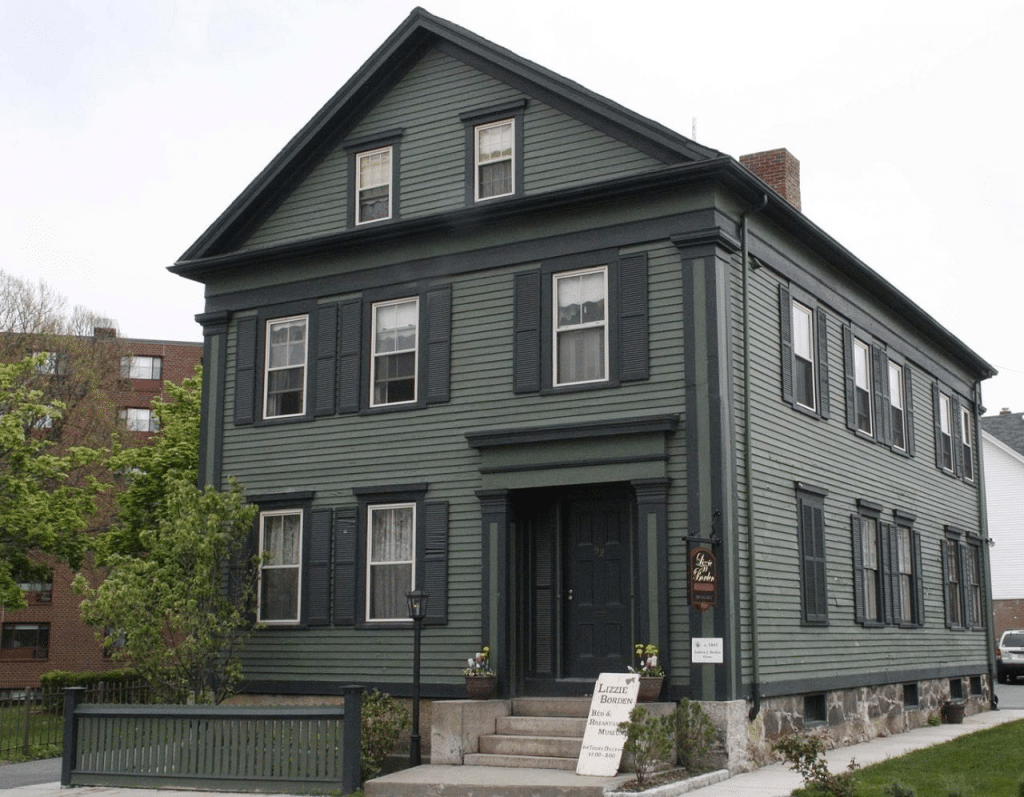 The grey and green exterior of the Lizzie Borden house
