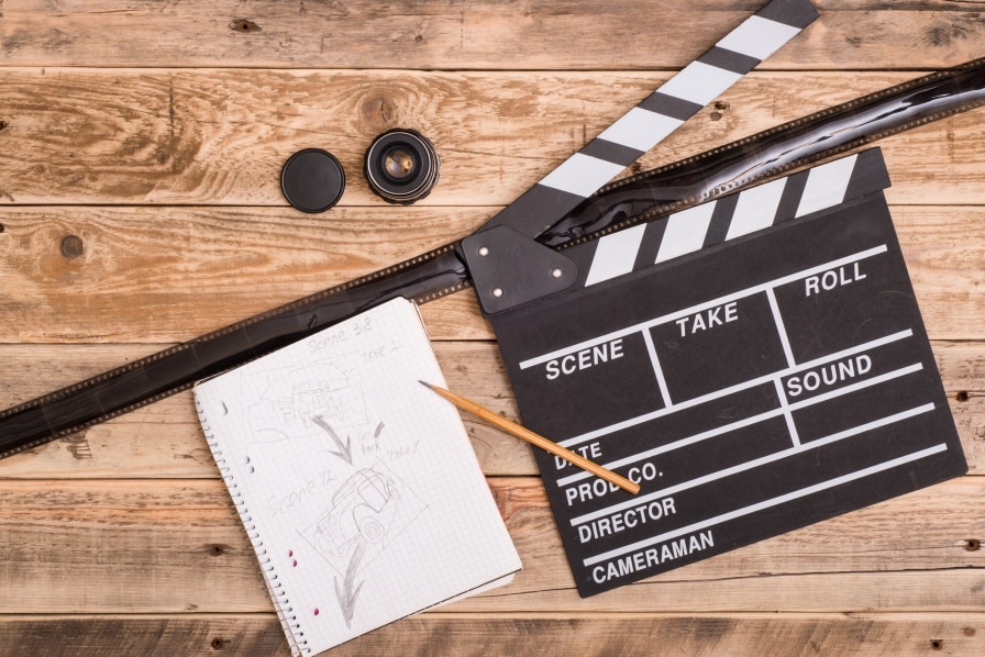 A piece of paper with a black film clapperboard