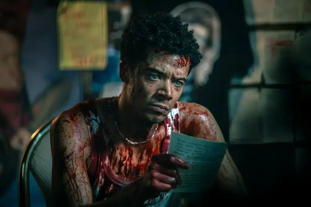 Louis de Pointe du Lac grips a page of Claudia's notebook, staring into the distance with a profoundly troubled look. He is soaked in blood.