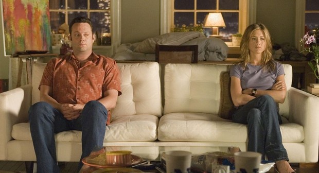 man and woman on opposites end of a couch