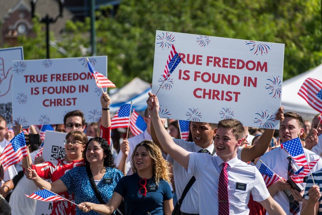 Group of Mormons at a rally with American flags