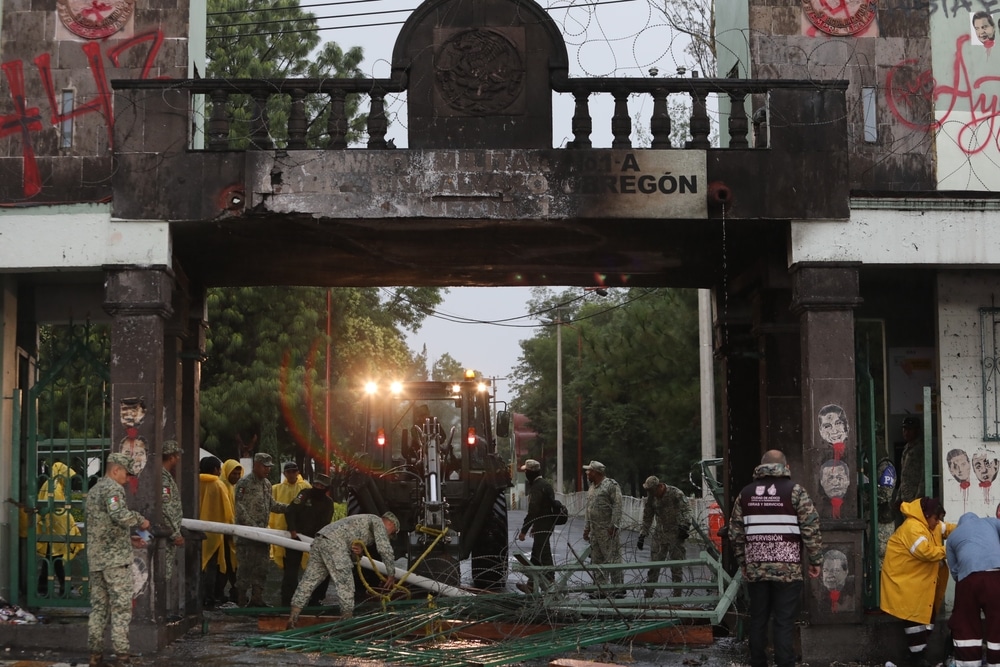 Mexico City, Mexico — September 25, 2025. During a protest over the disappearance of the 43 Ayotzinapa students, a bus was driven into and set on fire at the gates of Military Camp No. 1.