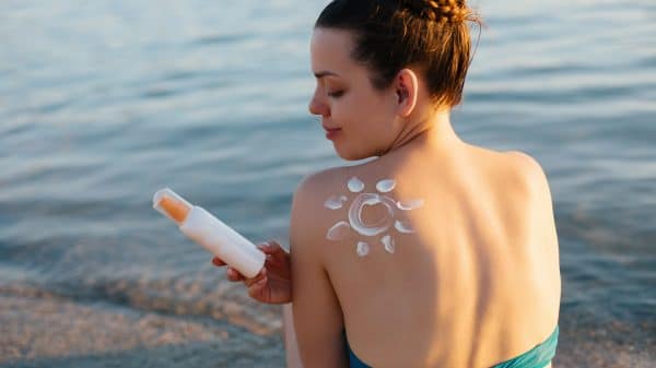 Woman staring at tanning product, picture from Shutterstock