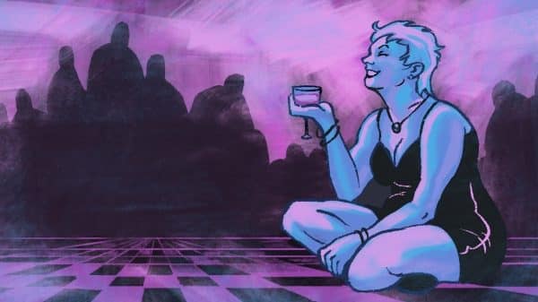A woman sits cross legged on a checkered floor, with a smile on her face and holding a glass of wine in one hand