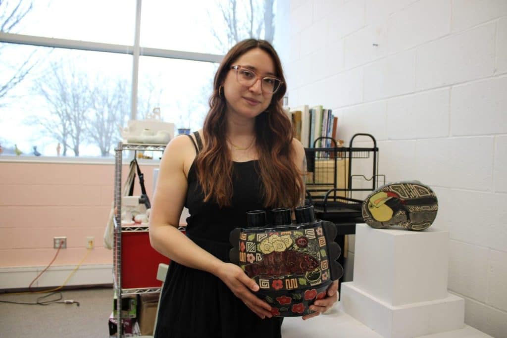 Kimberly LaVonne holding her ceramic vessel: an underrated artist.