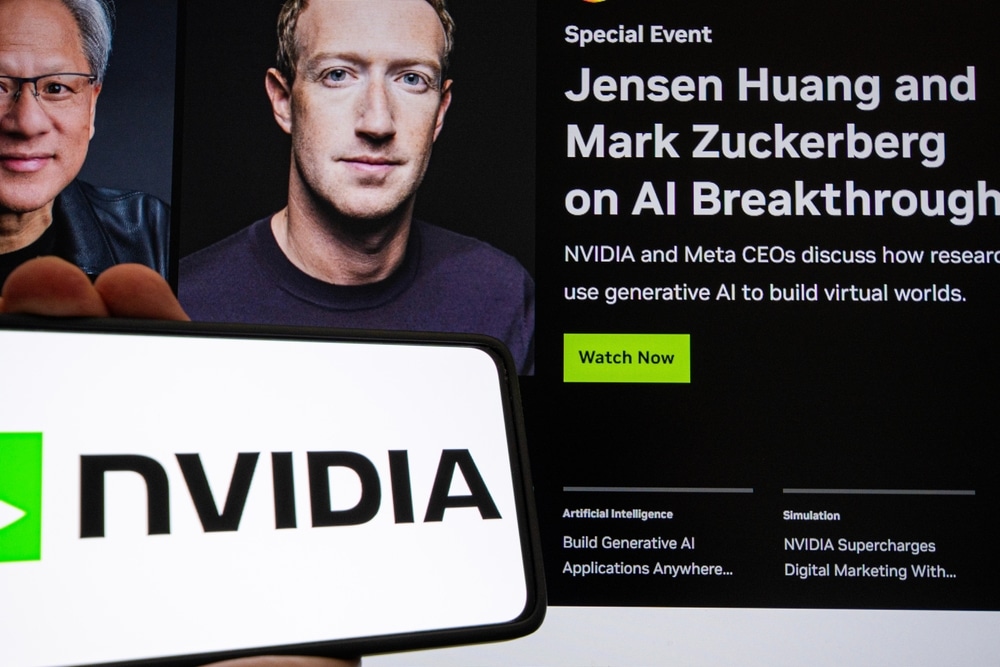 A phone being held up by a hand next to an article of Jensen Huang and Mark Zuckerberg