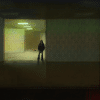 A creepy photo of a dark figure standing at the back of a dimly lit room