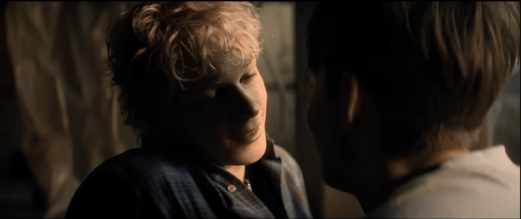 Ryan stares longingly at Naim's lips, a smile inching across his face.