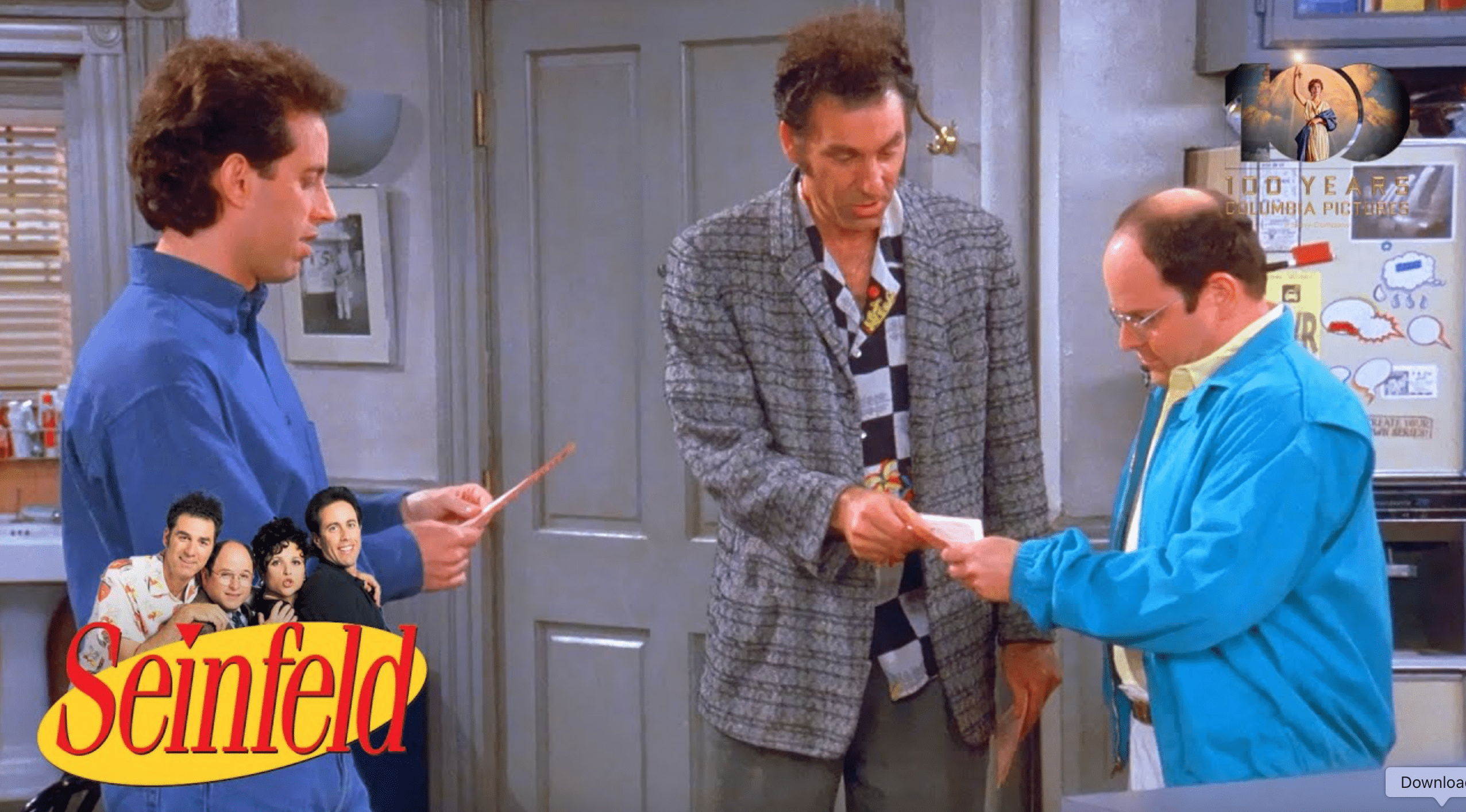 A still from the show "Seinfeld" of three men standing in a small apartment.