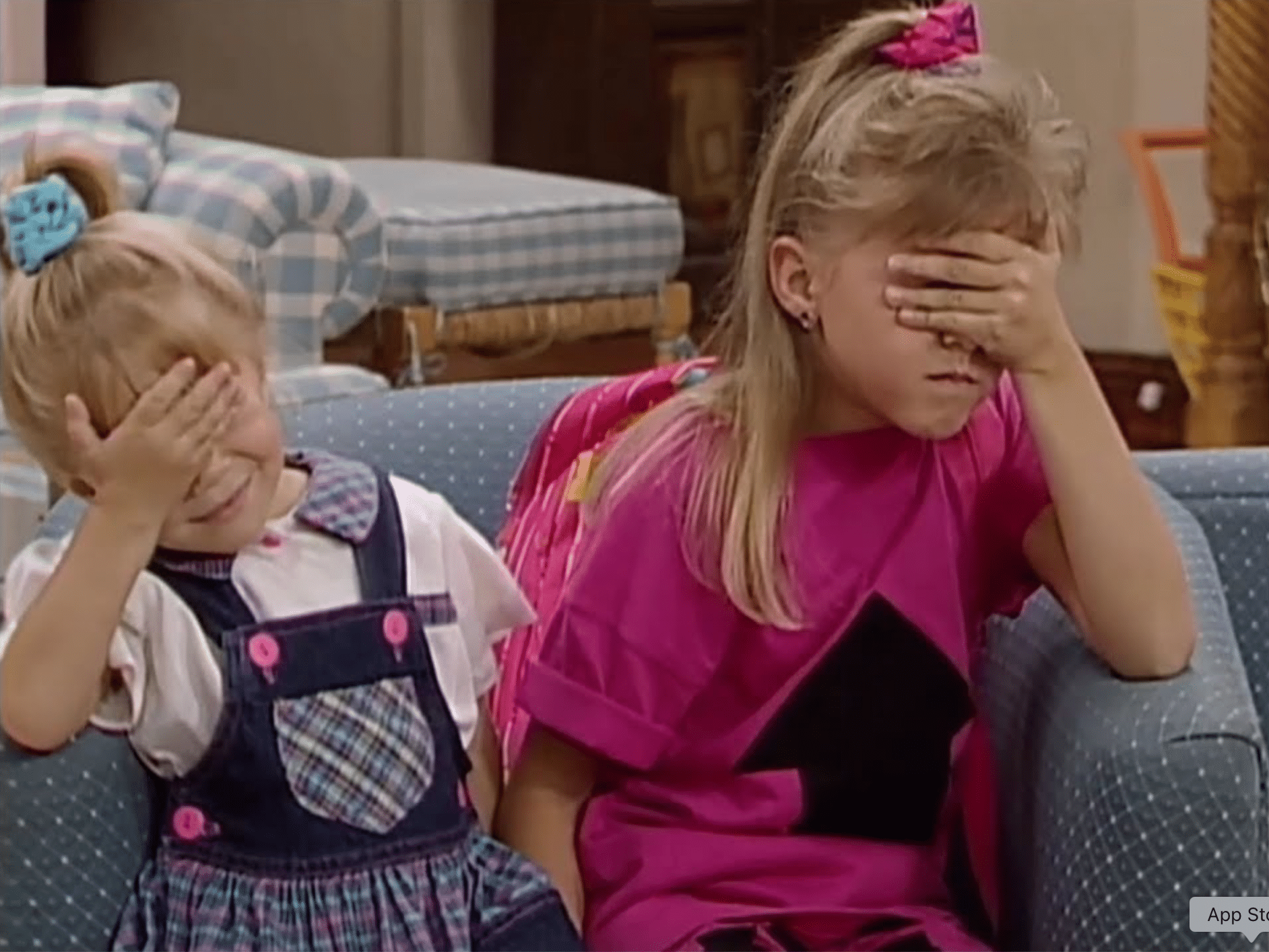 A still from "Full House" of two young girls facepalming.