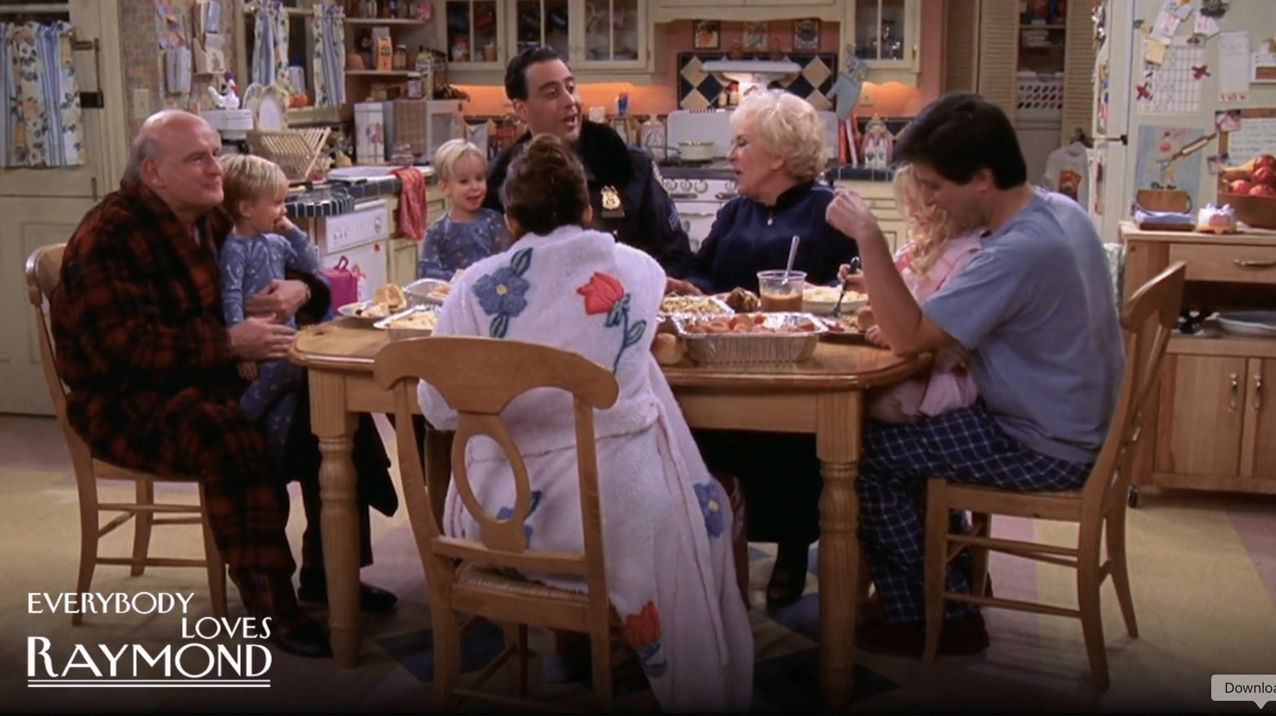 A still from "Everybody Loves Raymond" of a large family sitting around a dinner table.