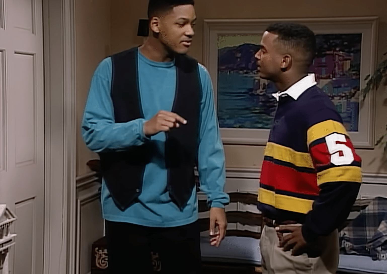 A still from "The Fresh Prince of Bel-Air" of two boys talking to each other and pointing.