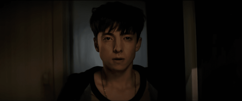 Naim tearfully stares past the camera at the Entity, which takes the form of Ryan.