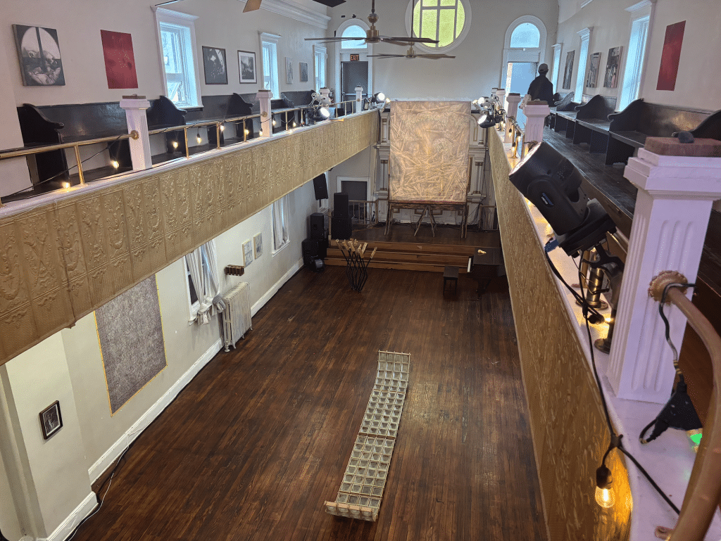Overhead photo of the church-turned-community-center-turned-gallery. Many different types of art are on display.