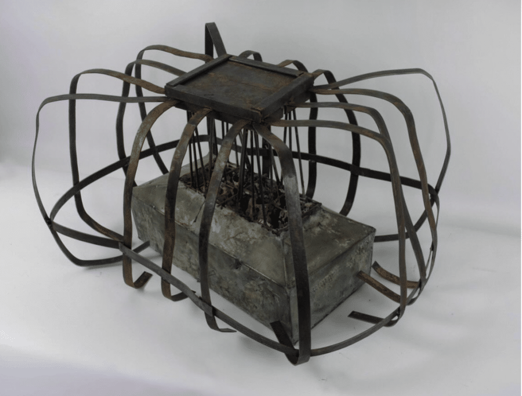 Elijah Smith's sculpture, which is an odd cage-like piece, with a hearth-like box in the center.