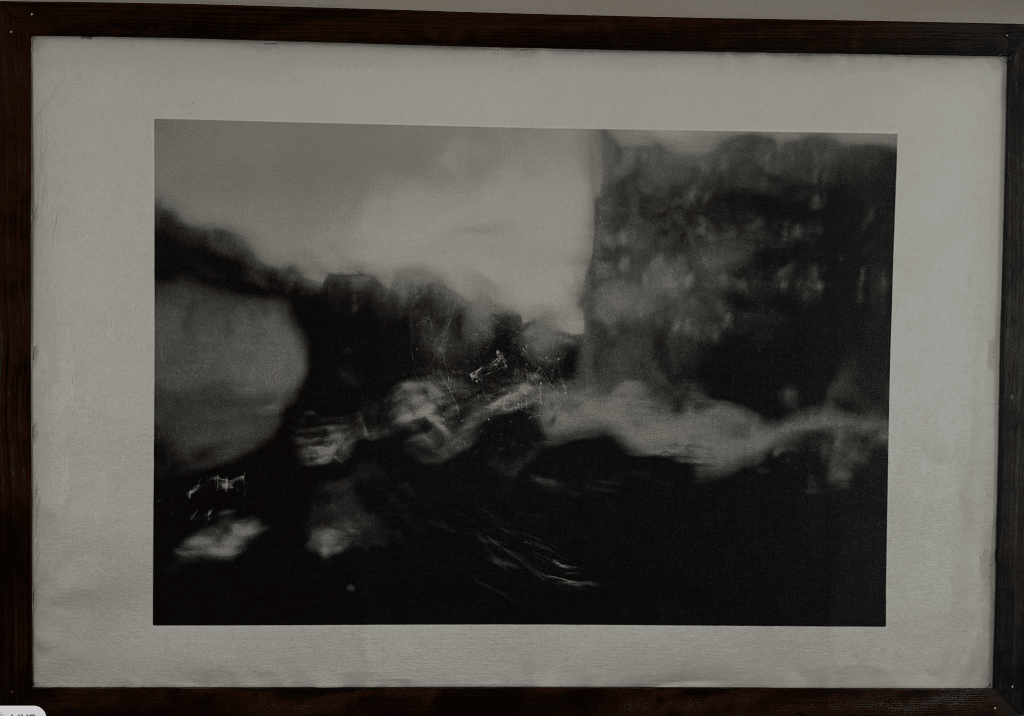 Black and white photo of a warped city, through a block of glass.