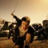 Canadian artist Jutes crouched down in a scrapyard performing for his music video Icarus
