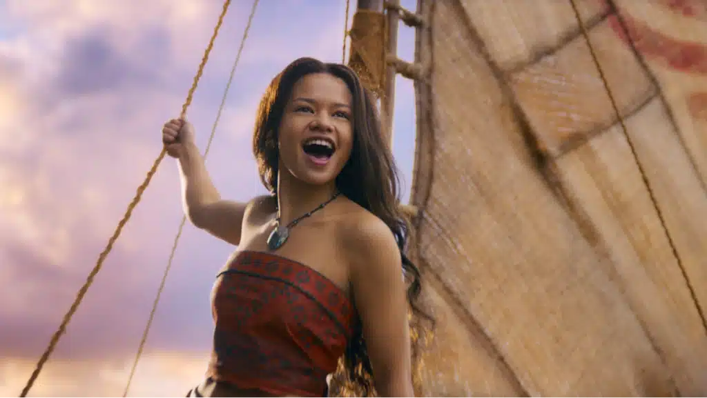A screencap of a scene from the live action 'Moana': Moana sings on her boat.
