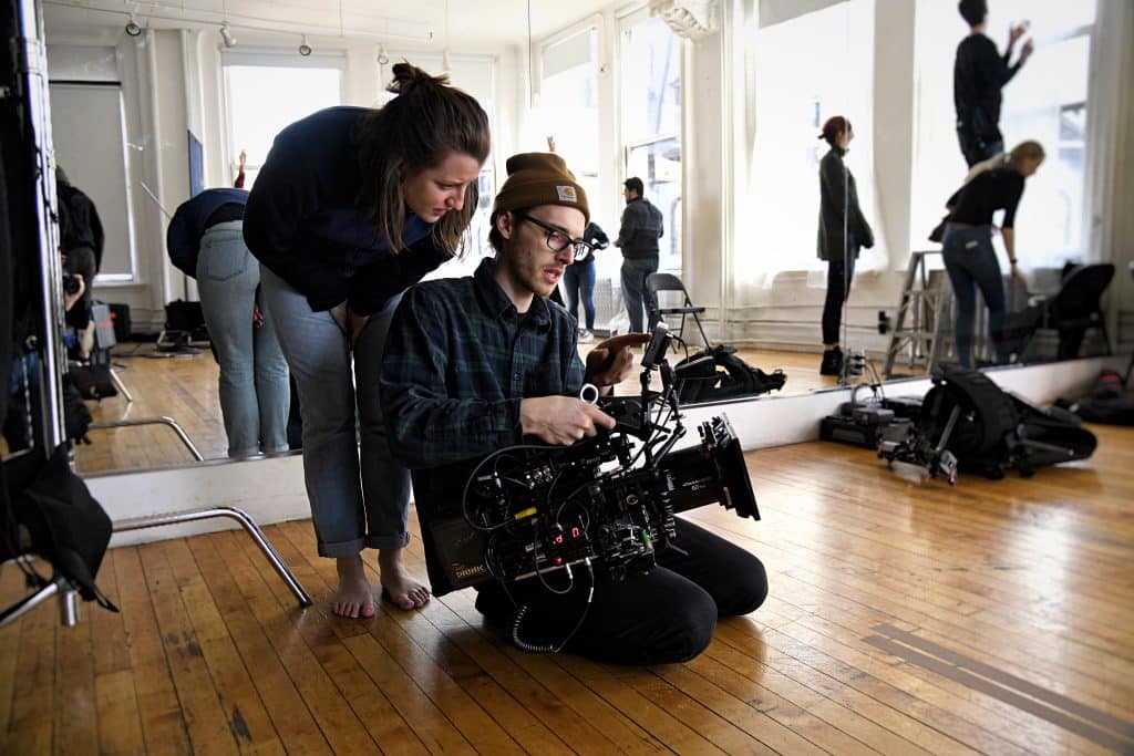 Director working another member of the production to set up a shot