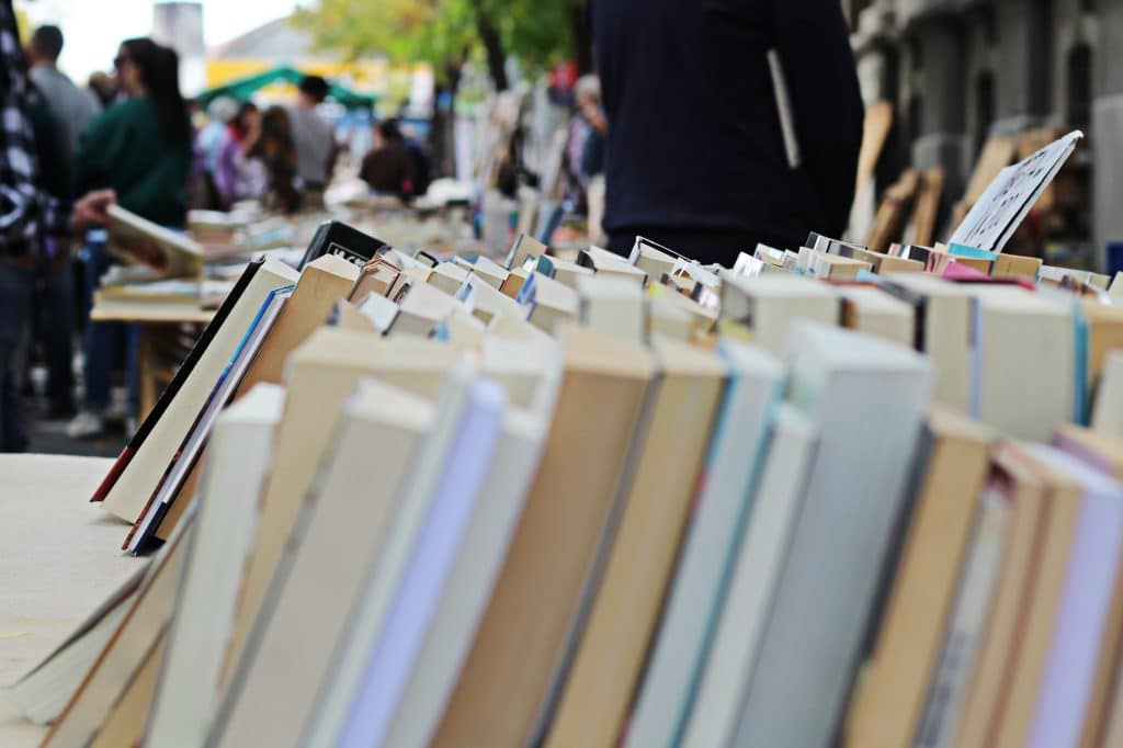An outdoor book market focusing on the rows of books
