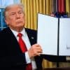 WASHINGTON, DC – January 20: President Donald Trump signs executive orders in the Oval Office of the White House on January 20, 2025, in Washington, DC. Trump assumes office for his second term as the 47th President of the United States.