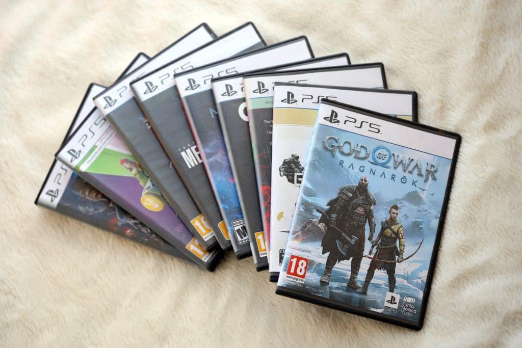 A set of games layered on top of each other rested upon a white sheet.