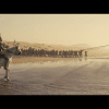 Odysseus leads a team of men in raising a monument.