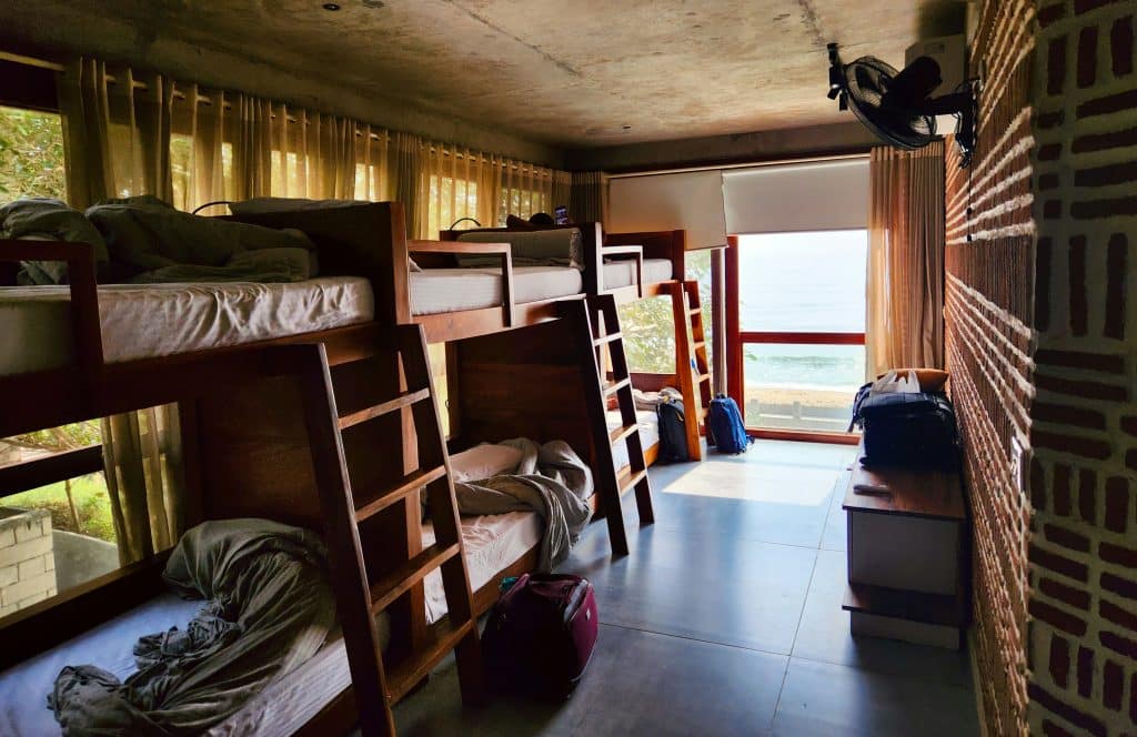 A hostel room with 3 bunk beds, accommodating six people total